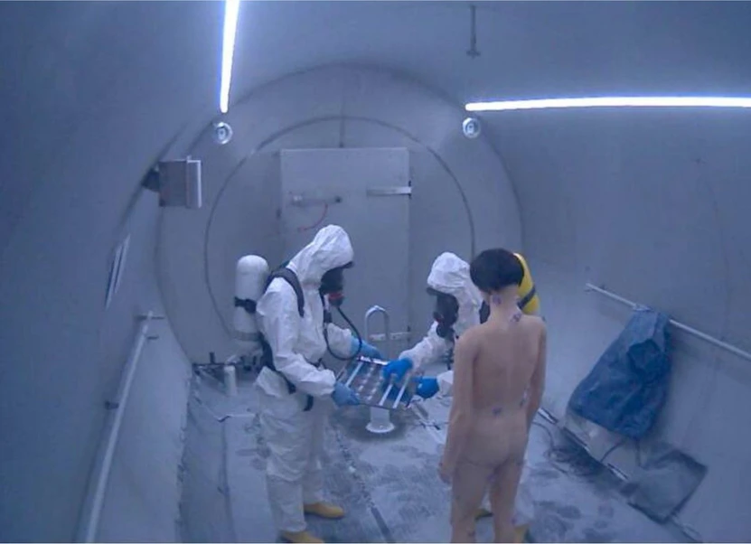 SÚJCHBO: Obrázek 2 - Připevňování kelímků s kontaminovanou umělou kůží na manekýna před dekontaminací